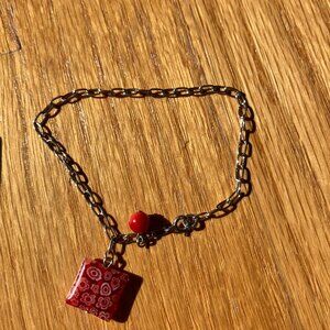Red glass and silver bracelet